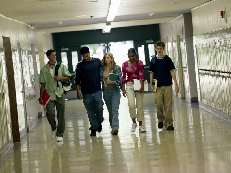 Large group of Indian school students in uniform walking through a school corridor — representing the 87% who receive no professional career guidance