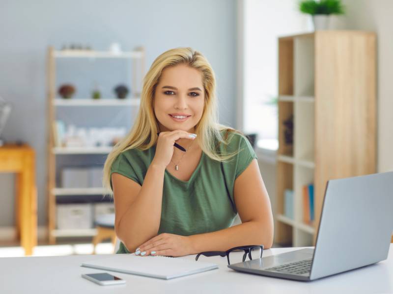Confident mid-career professional working at a laptop with clarity and direction — not everyone needs career counselling